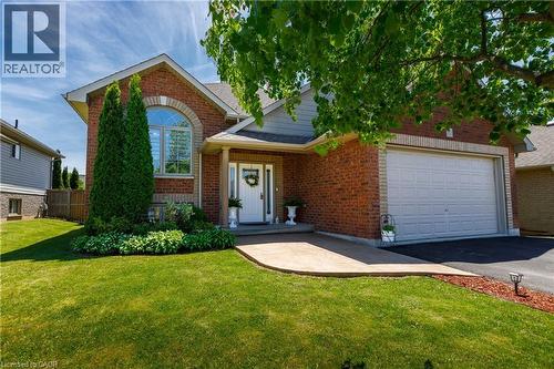 Brick exterior with a peaked roofline, an arched window, and an attached two-car garage - 10 Redbud Crescent, Simcoe, ON - Outdoor