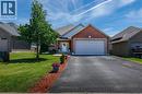 Brick facade residence with an attached two-car garage, asphalt driveway, and a manicured lawn - 10 Redbud Crescent, Simcoe, ON  - Outdoor 