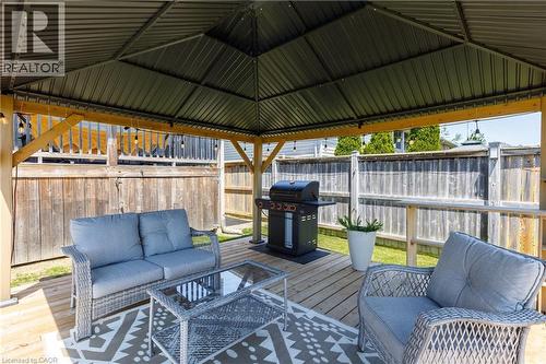 Covered outdoor living space featuring a metal gazebo roof and a wood-finish deck - 10 Redbud Crescent, Simcoe, ON - Outdoor With Deck Patio Veranda With Exterior