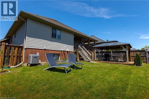 Expansive green space featuring a multi-level wooden deck with stairs - 10 Redbud Crescent, Simcoe, ON - Outdoor With Deck Patio Veranda