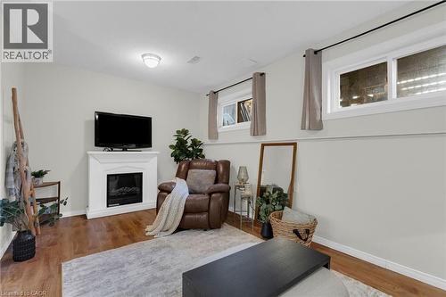 Large Windows to Private Backyard - 4 Parkside Crescent, Angus, ON - Indoor Photo Showing Other Room With Fireplace