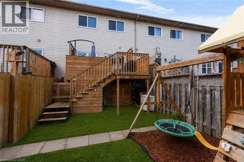 Expansive backyard featuring a multi-level wood deck, wood fencing, and a manicured lawn - 4 Parkside Crescent, Angus, ON - Outdoor With Deck Patio Veranda With Exterior
