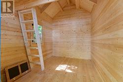 Interior of bunkie, ladder to loft with window - 