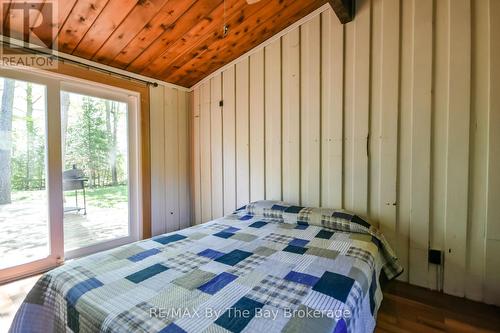 Primary Bedroom with walk-out to the deck - 22 Talon Trail, Tiny, ON - Indoor Photo Showing Bedroom