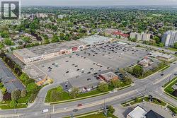 Expansive commercial plaza with extensive surface parking, multiple retail storefronts, and direct street frontage - 