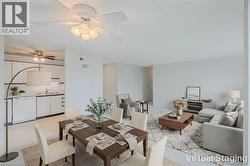 Open-concept living and dining area featuring clean white walls and a ceiling fan with integrated lighting - 