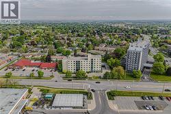 Panoramic aerial perspective showcasing a residential area with a mix of housing types, mature tree canopy, and established infrastructure - 