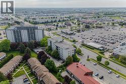 Aerial overview of a developed urban area featuring multiple residential and commercial structures - 
