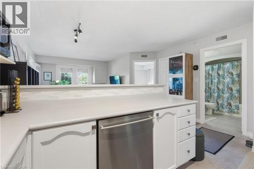 Balcony with dark plank flooring and metal railing - 1421 Walkers Line Unit# 209, Burlington, ON - Outdoor With Exterior