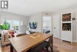 Open-concept living area with wood-finish flooring - 
