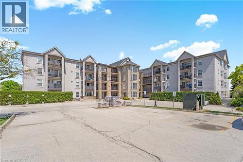 Stone exterior with multiple balconies and large windows - 1421 Walkers Line Unit# 209, Burlington, ON - Outdoor With Balcony With Facade
