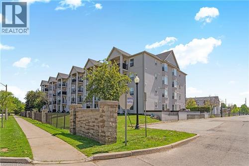 Stone block entry sign with wrought iron fencing - 1421 Walkers Line Unit# 209, Burlington, ON - Outdoor