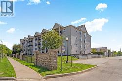 Multi-story building featuring light grey exterior siding and gable rooflines - 