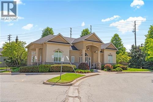 Dedicated storage units with wire mesh doors, concrete walls, concrete flooring, and overhead fluorescent lighting - 1421 Walkers Line Unit# 209, Burlington, ON - Indoor With Storage