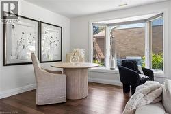 Hardwood flooring complements a bay window, offering natural illumination - 