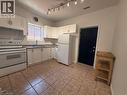 Kitchen featuring white cabinetry, a stainless steel sink, track lighting, and tiled flooring - 359 Barton Street E Unit# Upper, Hamilton, ON  - Indoor Photo Showing Kitchen With Double Sink 