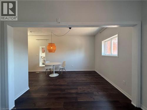 Open-concept living space featuring wide plank wood-finish flooring, light grey wall paint, and white trim - 359 Barton Street E Unit# Upper, Hamilton, ON - Indoor Photo Showing Other Room