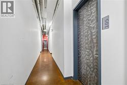 Hallway with polished concrete flooring and exposed ceiling ductwork - 
