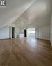 Spacious attic room featuring wood-finish flooring, white walls, and a sloped ceiling - 10 Fairleigh Avenue N, Hamilton, ON  - Indoor Photo Showing Other Room 