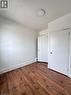 Room featuring wood-finish flooring, white walls, and a ceiling-mounted light fixture - 10 Fairleigh Avenue N, Hamilton, ON  - Indoor Photo Showing Other Room 
