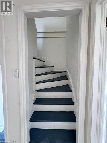 Compact interior staircase featuring dark treads and light risers - 10 Fairleigh Avenue N, Hamilton, ON - Indoor Photo Showing Other Room