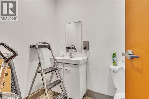 Single vanity with a white rectangular sink, chrome faucet, and mirrored medicine cabinet - 5 Manitou Drive Unit# 106B, Kitchener, ON 