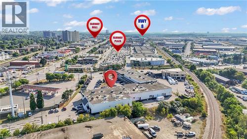 Aerial perspective of a commercial property surrounded by a bustling urban landscape - 5 Manitou Drive Unit# 106B, Kitchener, ON 