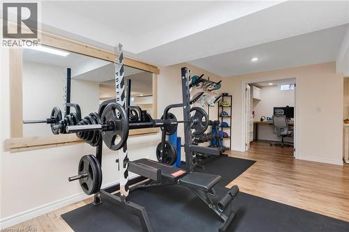 Dedicated exercise space with a full-width wall mirror framed in light-toned wood - 42 Handorf Drive, Cambridge, ON - Indoor Photo Showing Gym Room