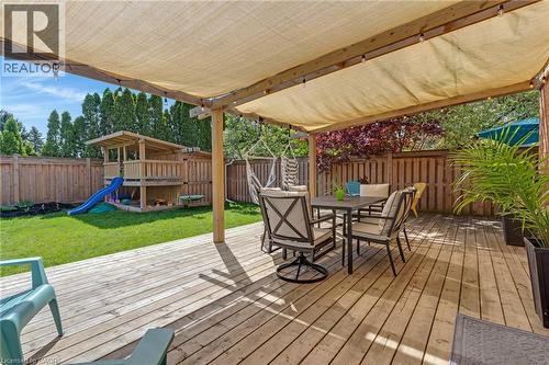Expansive wood deck with a retractable shade canopy and string lighting - 42 Handorf Drive, Cambridge, ON - Outdoor With Deck Patio Veranda