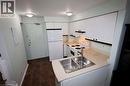 Compact kitchen featuring white cabinetry and appliances - 67 Valleyview Road Unit# 58, Kitchener, ON  - Indoor Photo Showing Kitchen With Double Sink 