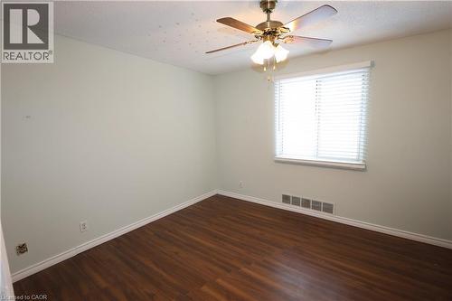 Room featuring wood-finish flooring, a ceiling fan with integrated lighting, and a window equipped with horizontal blinds - 67 Valleyview Road Unit# 58, Kitchener, ON - Indoor Photo Showing Other Room