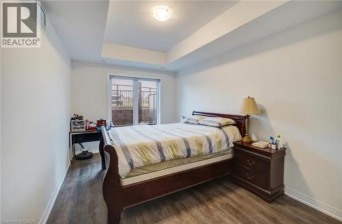Spacious room with wood-finish flooring, light-colored walls, and a sliding glass door leading to an exterior area - 2635 William Jackson Drive Unit# 705, Pickering, ON - Indoor Photo Showing Bedroom
