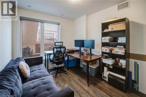 Room featuring a large window, recessed lighting, wood-finish flooring, and a built-in shelving unit - 2635 William Jackson Drive Unit# 705, Pickering, ON - Indoor Photo Showing Office