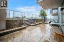 Spacious outdoor patio featuring stone paver flooring, a raised garden bed with retaining wall, and a metal railing - 2635 William Jackson Drive Unit# 705, Pickering, ON  - Outdoor With Exterior 