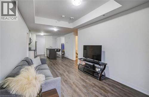 Open-concept living area featuring wood-finish flooring, recessed lighting, and a kitchen island with seating - 2635 William Jackson Drive Unit# 705, Pickering, ON - Indoor