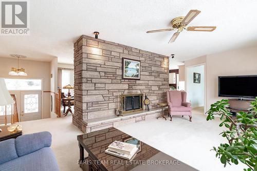 21 Pooles Road, Springwater, ON - Indoor Photo Showing Living Room With Fireplace