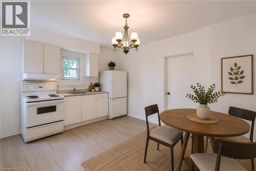 Bright kitchen and dining area featuring light wood-finish flooring - 87 Lancaster Street W, Kitchener, ON - Indoor Photo Showing Dining Room