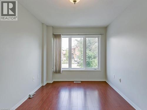 Bright room featuring a multi-pane window, wood-finish flooring, and light-toned walls - 1310 Blanshard Drive, Burlington, ON - Indoor Photo Showing Other Room
