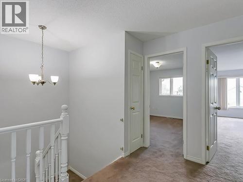 Upper-level hallway with textured wall-to-wall carpeting and neutral wall paint - 1310 Blanshard Drive, Burlington, ON - Indoor Photo Showing Other Room
