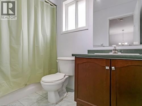 Bathroom featuring a vanity with wood-finish cabinetry, a single basin sink, and a counter-depth mirror - 1310 Blanshard Drive, Burlington, ON - Indoor Photo Showing Bathroom