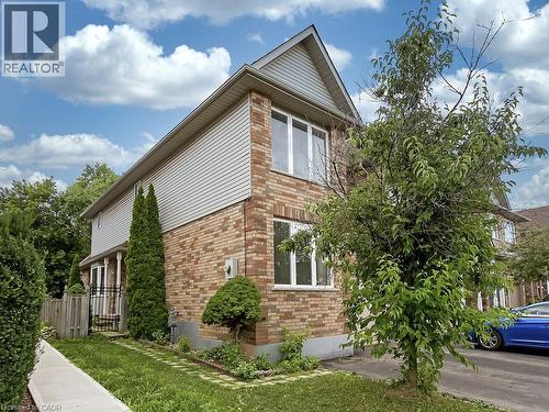 Brick and siding exterior featuring white-framed windows, a gabled roofline, and established landscaping - 1310 Blanshard Drive, Burlington, ON - Outdoor
