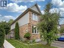Brick and siding exterior featuring white-framed windows, a gabled roofline, and established landscaping - 1310 Blanshard Drive, Burlington, ON  - Outdoor 