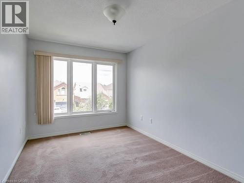 Light-filled interior space featuring a large three-panel window, light-colored walls, and neutral-toned carpeting - 1310 Blanshard Drive, Burlington, ON - Indoor Photo Showing Other Room