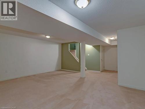 Expansive open-concept room featuring plush carpeting, a painted staircase, and recessed lighting - 1310 Blanshard Drive, Burlington, ON - Indoor