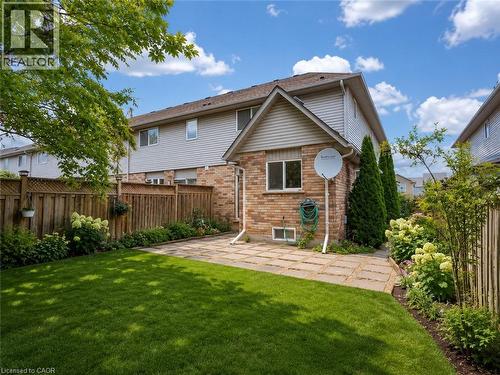 Expansive backyard featuring a manicured lawn, a paver stone patio, and mature perimeter landscaping - 1310 Blanshard Drive, Burlington, ON - Outdoor