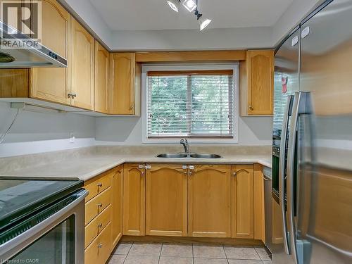 Kitchen featuring light wood cabinetry, light countertops, stainless steel appliances, and a window above the sink - 1310 Blanshard Drive, Burlington, ON - Indoor Photo Showing Kitchen With Stainless Steel Kitchen With Double Sink