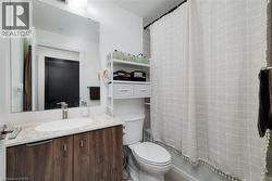 Full bathroom featuring shower / tub combo, vanity, and toilet - 