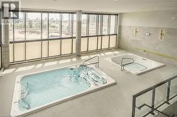 View of swimming pool featuring an indoor hot tub - 