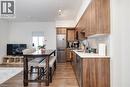 Kitchen with light hardwood / wood-style floors, stainless steel appliances, and tasteful backsplash - 15 Wellington Street S Unit# 1909, Kitchener, ON  - Indoor 