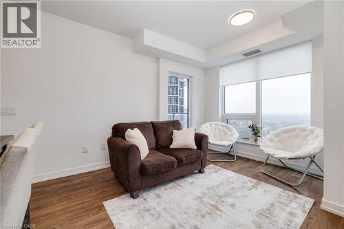 Living room with dark hardwood / wood-style floors - 15 Wellington Street S Unit# 1909, Kitchener, ON - Indoor Photo Showing Living Room